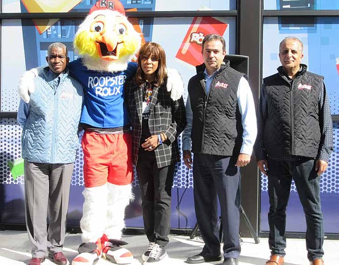 Roopster Roux creator Lavaille Lavette (C) poses with 17th Ward Ald. David Moore (L) and owners of The Roux gas station and convenience store, Naser Odeh and Mohammed Abdullah, following grand opening program at 7051 S. Western Ave. in the Chicago Lawn neighborhood. PHOTO PROVIDED BY THE PUBLICITY WORKS.