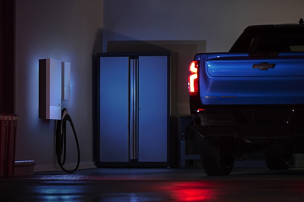 A 2024 Chevrolet Silverado RST in a residential home garage equipped with Ultium Home offerings. Show truck shown. Actual production model will vary. Model year 2024 Silverado EV expected to be available fall 2023