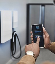 A customer uses GM’s energy software app, designed to enable greater energy management capabilities. Simulated charger shown, subject to change. App is preproduction and subject to change.