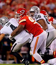 Derek Carr is tackled by Chris Jones after which a roughing-the-passer penalty call was called.
Mandatory Credit:	David Eulitt/Getty Images