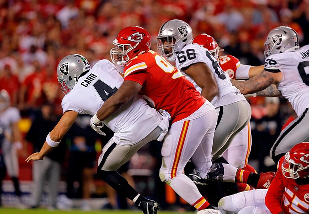 Derek Carr is tackled by Chris Jones after which a roughing-the-passer penalty call was called.
Mandatory Credit:	David Eulitt/Getty Images
