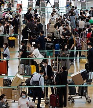 Travelers wait in line at the Vietnam Airlines JSC counter at South Korea's Incheon International Airport on September 8.
Mandatory Credit:	SeongJoon Cho/Bloomberg/Getty Images