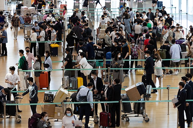 Travelers wait in line at the Vietnam Airlines JSC counter at South Korea's Incheon International Airport on September 8.
Mandatory Credit:	SeongJoon Cho/Bloomberg/Getty Images
