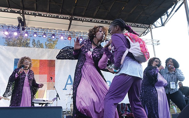 Blessing Williams is pulled on stage to jam with The Legendary Ingramettes on Oct. 8 during their performance at the Richmond Folk Festival.