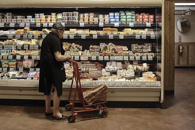 A shopper is shown at a supermarket in New York. On Thursday, Oct. 13, the U.S. government will announce what’s virtually certain to be the largest increase in Social Security benefits in 40 years. The boost is meant to allow beneficiaries to keep up with inflation, and plenty of controversy surrounds the move.