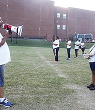 Members of Virginia State University’s Marching Band practice music and high-stepping routines before the school’s recent homecoming game. Taylor Whitehead is the interim band director for Virginia State University’s 120- member marching band, known as the “Trojan Explosion.”