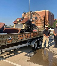 Fort Bend County Sheriff Eric Fagan and Northeast Fort Bend County Fire Chief Travis Baxter pause for a snapshot with the FBCSO airboat.