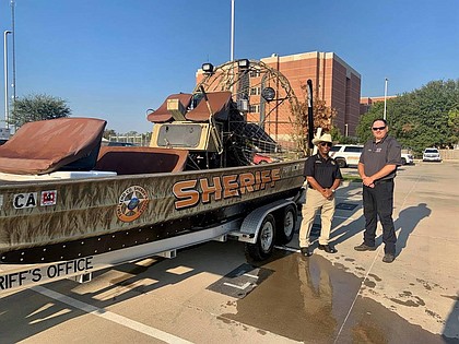 Fort Bend County Sheriff Eric Fagan and Northeast Fort Bend County Fire Chief Travis Baxter pause for a snapshot with the FBCSO airboat.