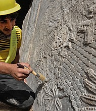 An Iraqi worker excavates a rock-carving relief recently found at the Mashki Gate, one of the monumental gates to the ancient Assyrian city of Nineveh, on the outskirts of what is today the northern Iraqi city of Mosul on October 19.
Mandatory Credit:	Zaid al-Obeidi/AFP/Getty Images
