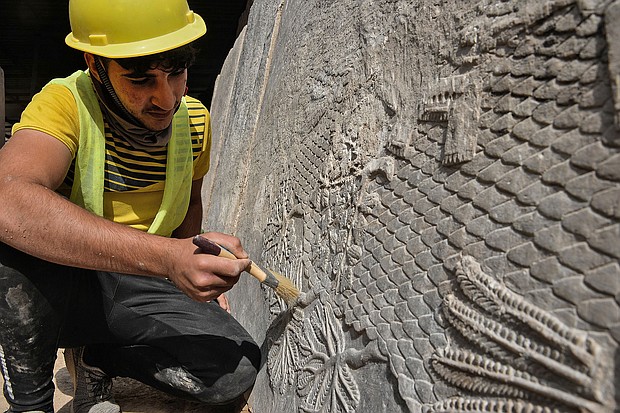 An Iraqi worker excavates a rock-carving relief recently found at the Mashki Gate, one of the monumental gates to the ancient Assyrian city of Nineveh, on the outskirts of what is today the northern Iraqi city of Mosul on October 19.
Mandatory Credit: Zaid al-Obeidi/AFP/Getty Images