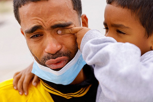 Saul, 4, wipes the tears of his father Franklin Pajaro on October 17 after they were expelled from the US and sent back to Mexico under Title 42.
Mandatory Credit: Jose Luis Gonzalez/Reuters