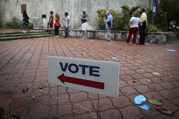 A Florida judge on Friday dismissed the case against a Miami man who was arrested on charges related to election fraud in August. A "Vote" sign is displayed in Miami on October 19, 2020.
Mandatory Credit:	Marco Bello/Bloomberg/Getty Images