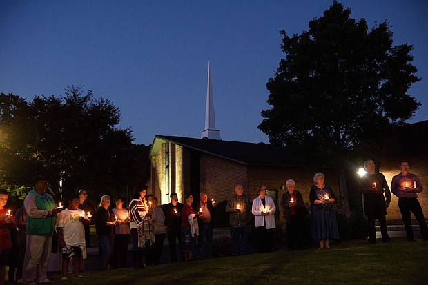 Mourners gather at Beacon Baptist Church for a vigil after five people were gunned down in Raleigh, North Carolina. The 15-year-old boy who allegedly killed five people and injured two last week in Raleigh was found with a shotgun, a handgun, and a knife.
Mandatory Credit:	Melissa Sue Gerrits/Getty Images