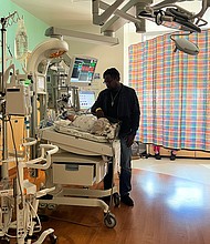 Stephen Balka stands over his son Adrian, who is hospitalized at Texas Children's Hospital with RSV.
Mandatory Credit: Rosa Flores/CNN