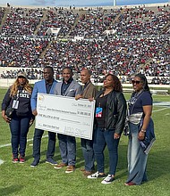 Rev. Howard-John Wesley, Senior Pastor of Alfred Street Baptist Church, presenting the check.