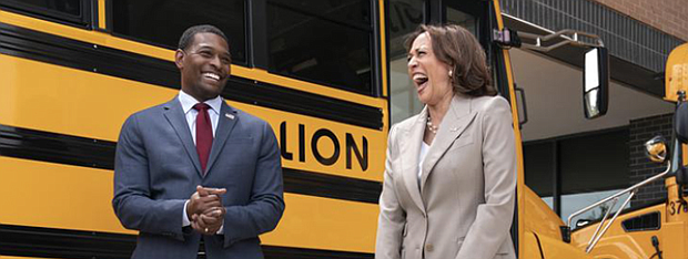 Vice President Kamala Harris, right, laughs with Environmental Protection Agency Administrator Michael Regan, during a tour of electric school buses in May 2022 at Meridian High School in Falls Church.