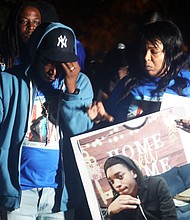 Tamel Durant, a 17-year-old Richmond Alternative School student, was looking forward to graduating next spring. He won’t. His body was found in a trash can after he who was shot and killed in Fairfield Court on Oct. 19.
The teen moved to Richmond two years ago from New York to live with his father, Jemil Durant, right. He was described as quiet, someone who was turning his life around. A Golden State Warriors fan, he loved Steph Curry. During a Monday, Oct. 24, vigil organized by James E. “J.J.” Minor III, president of the Richmond Branch NAACP, family and loved ones gathered to remember and honor the shortened life of Tamel.