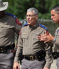 Steven McCraw, center, the Texas Department of Public Safety's top official, is due to deliver the first formal, public update to his agency's oversight panel on its officers' actions during the May massacre at a Uvalde elementary school.
Mandatory Credit:	Michael M Santiago/Getty Images