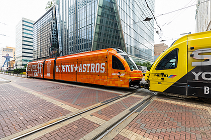 METRO's 2022 Houston Astros World Series-themed LRV features an eye-catching wrap showcasing the team's bold orange and white colors, and its "Level Up" slogan.