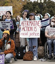 People rally outside the Supreme Court in Washington on Monday as the court begins to hear oral arguments in two cases that could decide the future of affirmative action in college admissions.