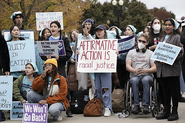 People rally outside the Supreme Court in Washington on Monday as the court begins to hear oral arguments in two cases that could decide the future of affirmative action in college admissions.