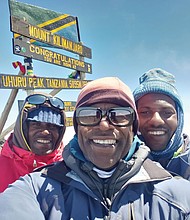 Robert Dortch at the summit of Mount Kilimanjaro with two of his Tanzanian guides, left John Masawe, Robert Dortch and Emmanuel Kimaro.