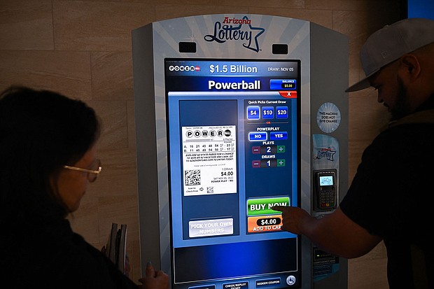 The "world's largest lotto prize ever offered" -- an estimated $1.6 billion jackpot -- is now at stake in Saturday's Powerball drawing. People purchase lottery tickets inside the Phoenix Sky Harbor International Airport in Arizona, on November 3.
Mandatory Credit:	Patrick T. Fallon/AFP/Getty Images