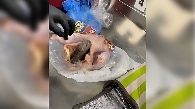 A gun was found inside a raw chicken at an airport security checkpoint.
Mandatory Credit: TSA