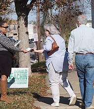 Rae Cousins campaigns for incumbent congressional candidate A. Donald McEachin in the 800 block of 31st Street near in Church Hill on Tuesday.