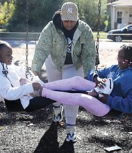 Barack Obama Elementary School students Shaliya Johnson, 10, a fourth-grader, left, and Aaminah Sineus, 9, a third-grader, where shown the “banana split,” push by program leader, Mone “Miss Mo” Jones on Tuesday, Nov. 8. Schools were out due to Election Day, so the students spent time at the Boys and Girls Club of Metro Richmond Northside Club at 3601 Branch Ave.