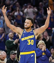 Golden State Warriors guard Stephen Curry (30) celebrates Monday after shooting a 3-point basket against the Sacramento Kings during the second half of an NBA basketball game in San Francisco.