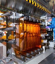 General Motors Fuel Cell Controls and Process Engineer Joe Truchan operates a coating machine in the fuel cell laboratory at the GM Global Propulsion Systems Pontiac Engineering Center in Pontiac, Michigan. (Photo by Steve Fecht for General Motors)
