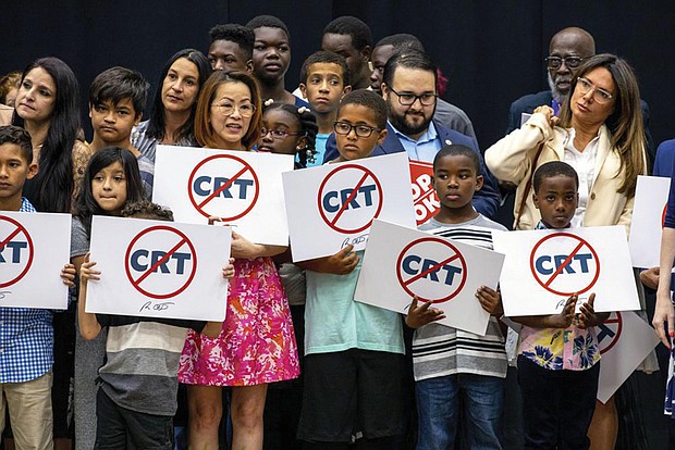 Children holding signs against Critical Race Theory stand on stage near Florida Gov. Ron DeSantis as he addresses the crowd before publicly signing HB7 at Mater Academy Charter Middle/High School in Hialeah Gardens, Fla., on April 22, 2022. Republican groups that sought to get hundreds of “parents’ rights” activists elected to local school boards largely fell short in this year’s Nov. 8 elections. The push has been boosted by Republican groups including the 1776 Project PAC, but just a third of its roughly 50 candidates won.