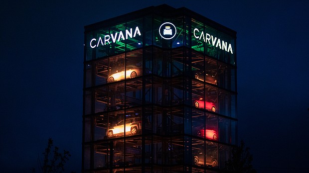 Signage outside a Carvana Vending Machine location in Novi, Michigan, is seen here in October 2021. Used-car retailer Carvana Co. is cutting 1,500 jobs, or 8% of its workforce.
Mandatory Credit:	Emily Elconin/Bloomberg/Getty Images