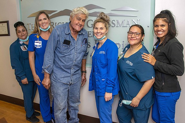 Jay Leno has been discharged from the hospital after sustaining burn injuries in a gasoline fire. Leno is seen here with the staff of the Grossman Burn Center on November 21.
Mandatory Credit:	From Grossman Burn Center