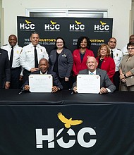 Houston Mayor Sylvester Turner and HCC Chancellor Cesar Maldonado sign a three-year training agreement at HCC’s Northeast College, surrounded by college leaders, trustees and Fire Department executive team members.
