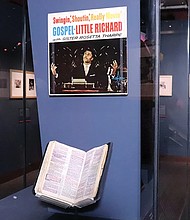 A Bible owned by Little Richard, placed beneath an album cover titled “Swingin’, Shoutin, Really Movin’ Gospel” at “Spirit in the Dark: Religion in Black Music, Activism and Popular Culture,” a new exhibition of the Smithsonian’s National Museum of African American History and Culture.