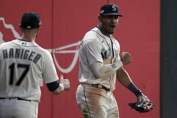 Seattle Mariners center fielder Julio Rodriguez celebrates after making a catch for an out
against the Houston Astros.