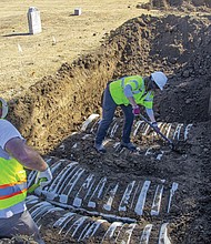 In this image provided by the city of Tulsa, Okla., crews work on an excavation Oct. 26 at Oaklawn Cemetery searching for victims of the 1921 Tulsa Race Massacre. The latest search for remains of victims of the massacre ended Friday, Nov. 18, with 32 additional caskets discovered and eight sets of remains exhumed, according to the city.