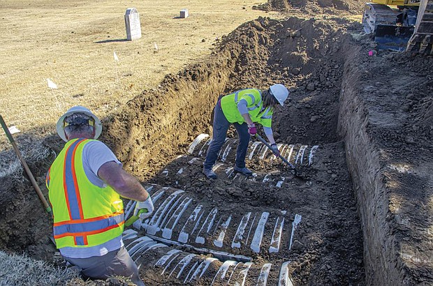 In this image provided by the city of Tulsa, Okla., crews work on an excavation Oct. 26 at Oaklawn Cemetery searching for victims of the 1921 Tulsa Race Massacre. The latest search for remains of victims of the massacre ended Friday, Nov. 18, with 32 additional caskets discovered and eight sets of remains exhumed, according to the city.