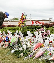 The suspect in Buffalo Tops mass shooting is expected to plead guilty to state charges Monday. Pictured is a memorial site outside the Tops supermarket in Buffalo, New York, on May 20.
Mandatory Credit:	Lindsay DeDario/Reuters
