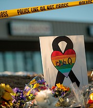 A sign at the growing memorial at the scene, related to the shooting inside Club Q on Sunday, November 20 in Colorado Springs, Colorado.
Mandatory Credit:	Matthew Staver for the Washington Post/Getty Images