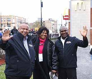 Marvin Spence, Doris Boulrece, and Akins Akinnagbe, members of the Black McDonald’s Operators Association, greet Food for the Body and Spirit turkey giveaway patrons. Photograph by Gregory Davis.
