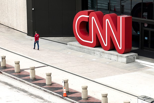 CNN begins layoffs in what CEO says will be a 'gut punch' to the network. People walk by the CNN headquarters on March 15, in Atlanta.
Mandatory Credit:	Anna Moneymaker/Getty Images