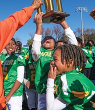 The RVA Trojans 10u football players representing Maggie Walker, celebrate their 6-0 win over the RVA Wildcats and Falcons, representing Armstrong in the Armstrong-Walker Legacy Classic Project football game.