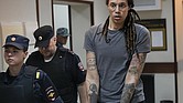WNBA star and two-time Olympic gold medalist Brittney Griner is escorted from a courtroom Aug. 4 after a hearing in Khimki just outside Moscow.