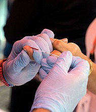 An experimental HIV vaccine has been found to induce broadly neutralizing antibodies among a small group of volunteers in a Phase 1 study. A health worker takes a blood sample from a woman to perform a rapid HIV test in Venezuela in 2021.
Mandatory Credit:	Yuri Cortez/AFP/Getty Images
