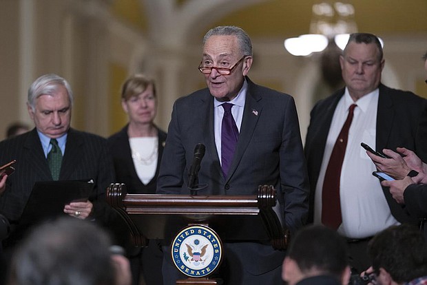 Senate Majority Leader Chuck Schumer, D-N.Y., joined from left by Sen. Jack Reed, D-R.I., chairman of the Senate Armed Services Committee, Sen. Tammy Baldwin, D-Wis., and Sen. Jon Tester, D-Mont., speaks to reporters Tuesday before a vote on legislation to protect same-sex and interracial marriages, at the Capitol.