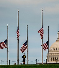 American flags are seen at half-staff surrounding the Washington Monument as people enjoy the weather on the National Mall on Wednesday, May 25 in Washington, DC.
Mandatory Credit:	Kent Nishimura/Los Angeles Times/Getty Images