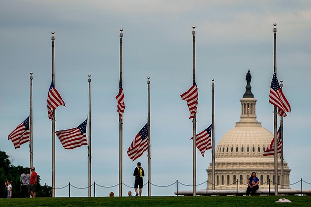 American flags are seen at half-staff surrounding the Washington Monument as people enjoy the weather on the National Mall on Wednesday, May 25 in Washington, DC.
Mandatory Credit:	Kent Nishimura/Los Angeles Times/Getty Images